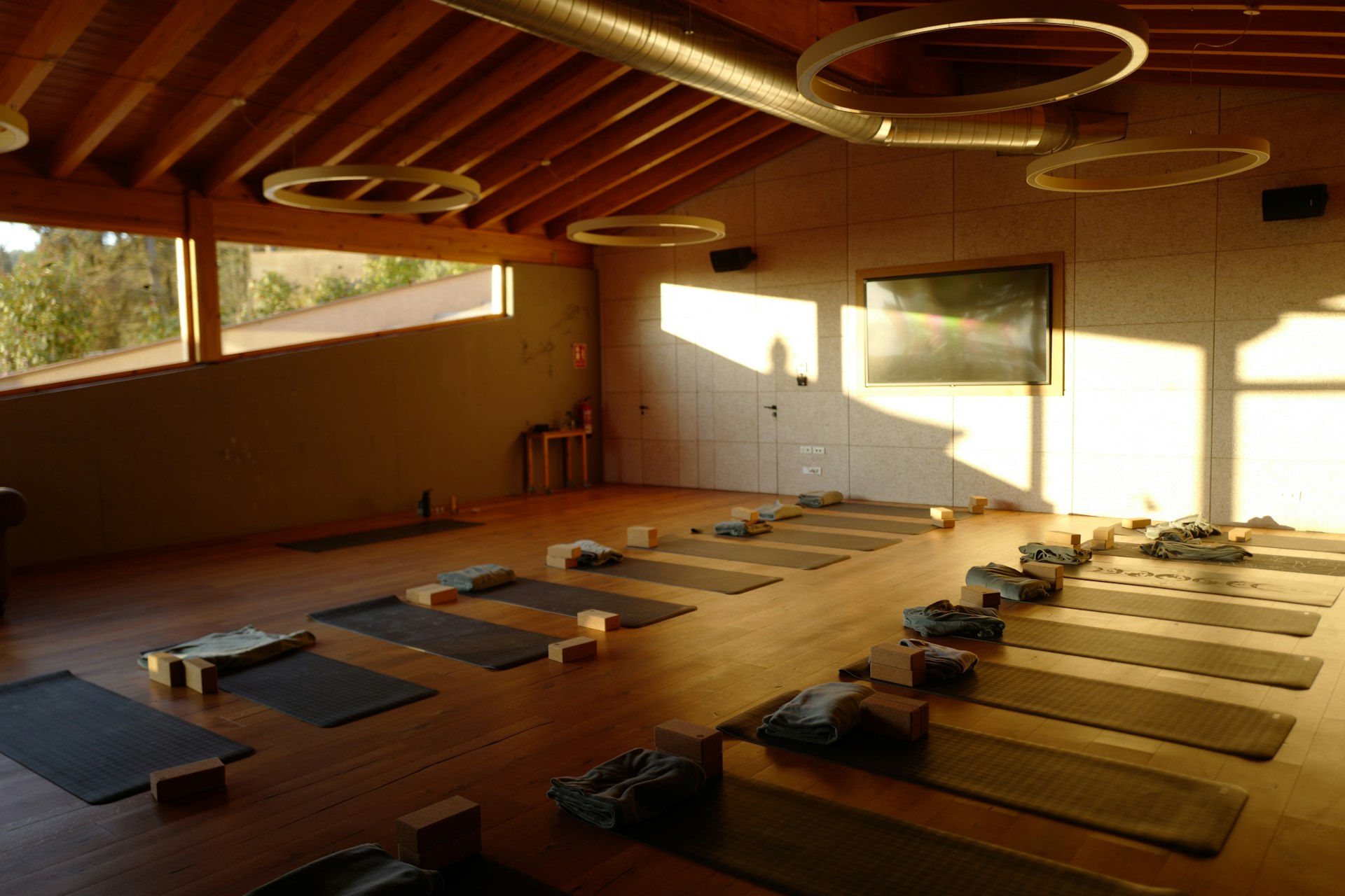 a large room with a lot of yoga mats on the floor